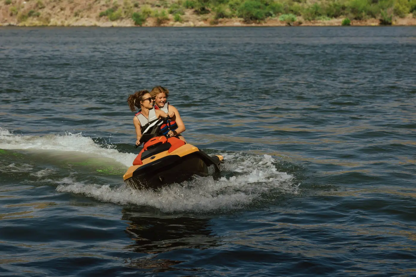 Couple riding a Sea-Doo Spark jet ski rental on an Arizona lake